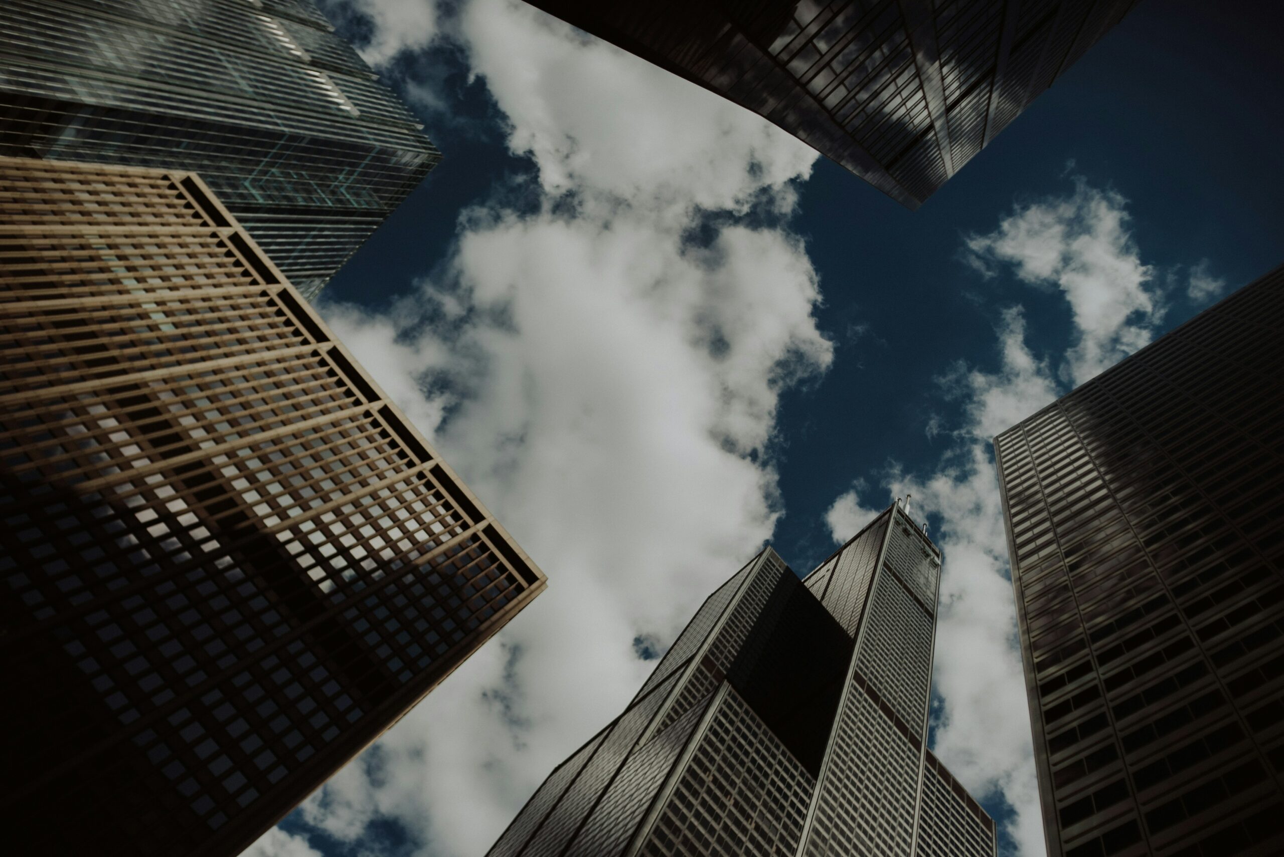 Looking up at sky surrounded by chicago skyscrapers